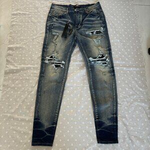Amiri Distressed Hole Jean In Blue